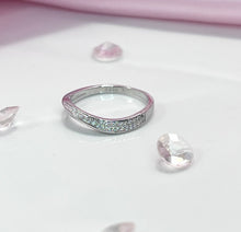 Load image into Gallery viewer, Representing modern simplicity, the fluid and flowing curves of this silver ring are enhanced by the row of brilliant cubic zirconia stones lined as accent stones. Each one radiates a stunning light comparable to expensive diamonds and will add a luxurious touch to any outfit you wear. Material: 925 Sterling Silver, Cubic Zirconia Design: Irregular Weight: 1.8g