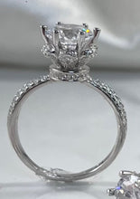 Load image into Gallery viewer, The timeless six-prong setting offers a flawlessly engineered facet to the head of the ring that radiates a stunning reflection comparable to one of the world’s most expensive diamonds. Lined along the upper shank are cubic zirconia accents stones, pointing your attention back to the glorious head. Material: 925 Sterling Silver, Cubic Zirconia Design: Classic Weight: 2.9g