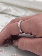 Load image into Gallery viewer, Representing modern simplicity, the fluid and flowing curves of this silver ring are enhanced by the row of brilliant cubic zirconia stones lined as accent stones. Each one radiates a stunning light comparable to expensive diamonds and will add a luxurious touch to any outfit you wear. Material: 925 Sterling Silver, Cubic Zirconia Design: Irregular Weight: 1.8g
