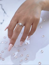 Load image into Gallery viewer, Three slim prongs surrounded by scintillating cubic zirconia stones form a heart-shaped head. This ring is a tangible representation of love and its many beautiful facets. The piece features a slender silhouette that is ideal for the woman who is never afraid to stand out through her unique personality. Material: 925 Sterling Silver, Cubic Zirconia Design: Heart Weight: 2.10g