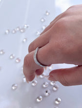 Load image into Gallery viewer, Representing modern simplicity, the fluid and flowing curves of this silver ring are enhanced by the row of brilliant cubic zirconia stones lined as accent stones. Each one radiates a stunning light comparable to expensive diamonds and will add a luxurious touch to any outfit you wear. Material: 925 Sterling Silver, Cubic Zirconia Design: Irregular Weight: 1.8g