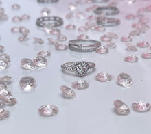 Load image into Gallery viewer, Three slim prongs surrounded by scintillating cubic zirconia stones form a heart-shaped head. This ring is a tangible representation of love and its many beautiful facets. The piece features a slender silhouette that is ideal for the woman who is never afraid to stand out through her unique personality. Material: 925 Sterling Silver, Cubic Zirconia Design: Heart Weight: 2.10g