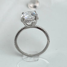 Load image into Gallery viewer,  Nothing will ever beat the slender shank adorned with brilliant cubic zirconia stones that shine like the stars in the heavens. And stealing all the spotlight is the large head of the ring, radiating light as if all the diamonds in the world have come together to become present in one ring. Hand-polished to perfection, you will love wearing this ring on its own or stacking it with other pieces to make the look more unique.  Material: 925 Sterling Silver, Cubic Zirconia  Design: Classic  Weight: 2.6g
