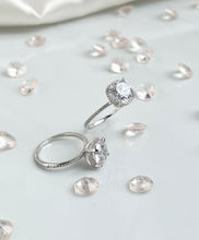 Load image into Gallery viewer,  Nothing will ever beat the slender shank adorned with brilliant cubic zirconia stones that shine like the stars in the heavens. And stealing all the spotlight is the large head of the ring, radiating light as if all the diamonds in the world have come together to become present in one ring. Hand-polished to perfection, you will love wearing this ring on its own or stacking it with other pieces to make the look more unique.  Material: 925 Sterling Silver, Cubic Zirconia  Design: Classic  Weight: 2.6g
