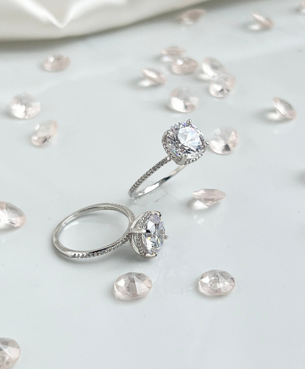  Nothing will ever beat the slender shank adorned with brilliant cubic zirconia stones that shine like the stars in the heavens. And stealing all the spotlight is the large head of the ring, radiating light as if all the diamonds in the world have come together to become present in one ring. Hand-polished to perfection, you will love wearing this ring on its own or stacking it with other pieces to make the look more unique.  Material: 925 Sterling Silver, Cubic Zirconia  Design: Classic  Weight: 2.6g
