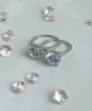 Load image into Gallery viewer,  Nothing will ever beat the slender shank adorned with brilliant cubic zirconia stones that shine like the stars in the heavens. And stealing all the spotlight is the large head of the ring, radiating light as if all the diamonds in the world have come together to become present in one ring. Hand-polished to perfection, you will love wearing this ring on its own or stacking it with other pieces to make the look more unique.  Material: 925 Sterling Silver, Cubic Zirconia  Design: Classic  Weight: 2.6g
