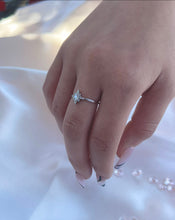 Load image into Gallery viewer,  The radiant cubic zirconia stones that adorn the head of the ring transforms it into a luxurious piece of accessory any woman will want on their finger. Hand-polished to perfection, you will love wearing this ring on its own or stacking it with other pieces to make the look more unique.  Material: 925 Sterling Silver, Cubic Zirconia  Design: Star  Weight: 1.0g
