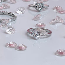 Load image into Gallery viewer, The large heart-shaped head is made from premium quality cubic zirconia, radiating the same beautiful reflection you will get from a lavish diamond. Hand-polished to perfection, you will love wearing this ring on its own or stacking it with other pieces to make the look more unique.  Material: 925 Sterling Silver, Cubic Zirconia  Design: Heart  Weight: 1.7g
